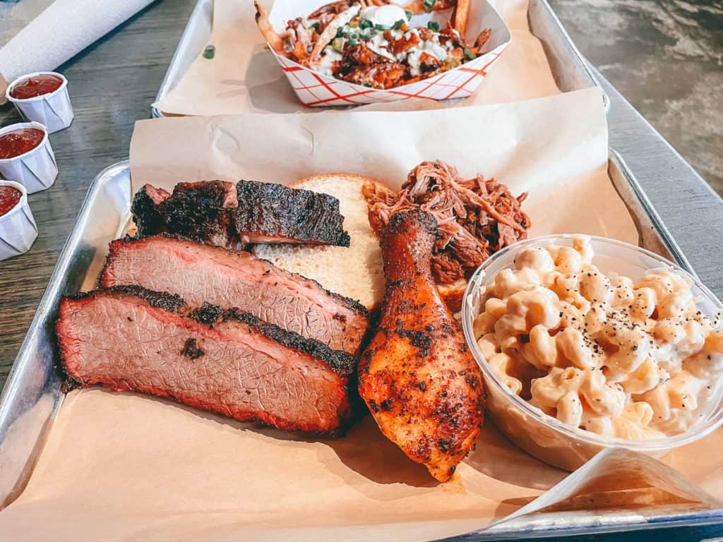 bbq meat and mac and cheese on a metal tray 