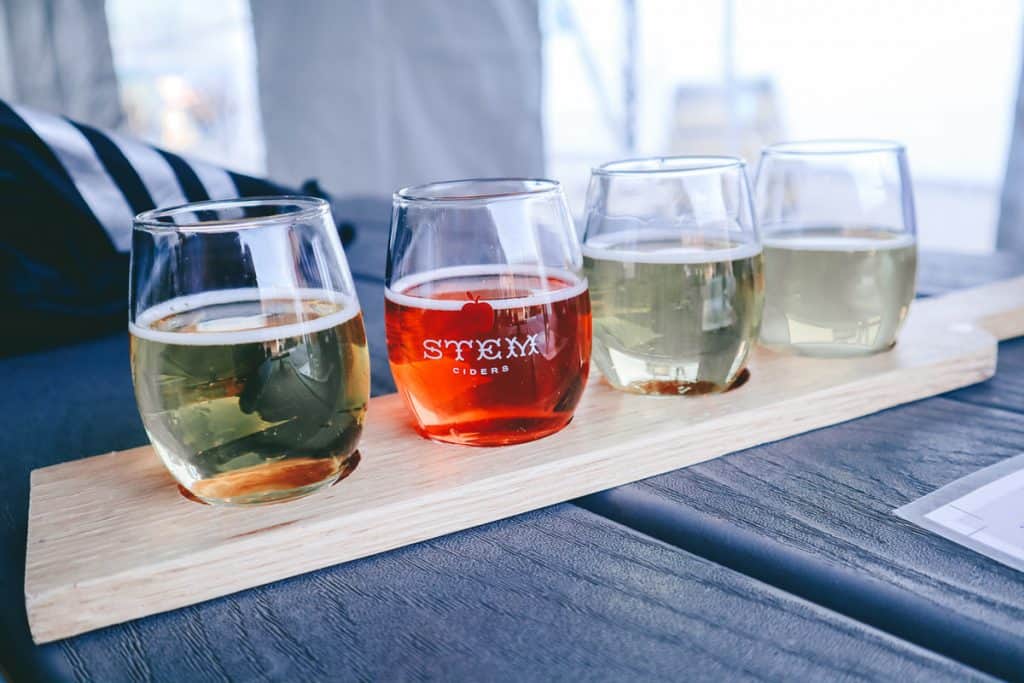 flight of small glasses with cider 