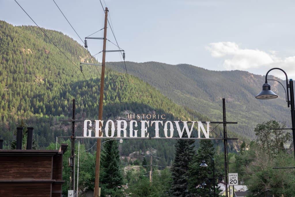 Sign leading to a town in the mountains that reads "Historic Georgetown". 