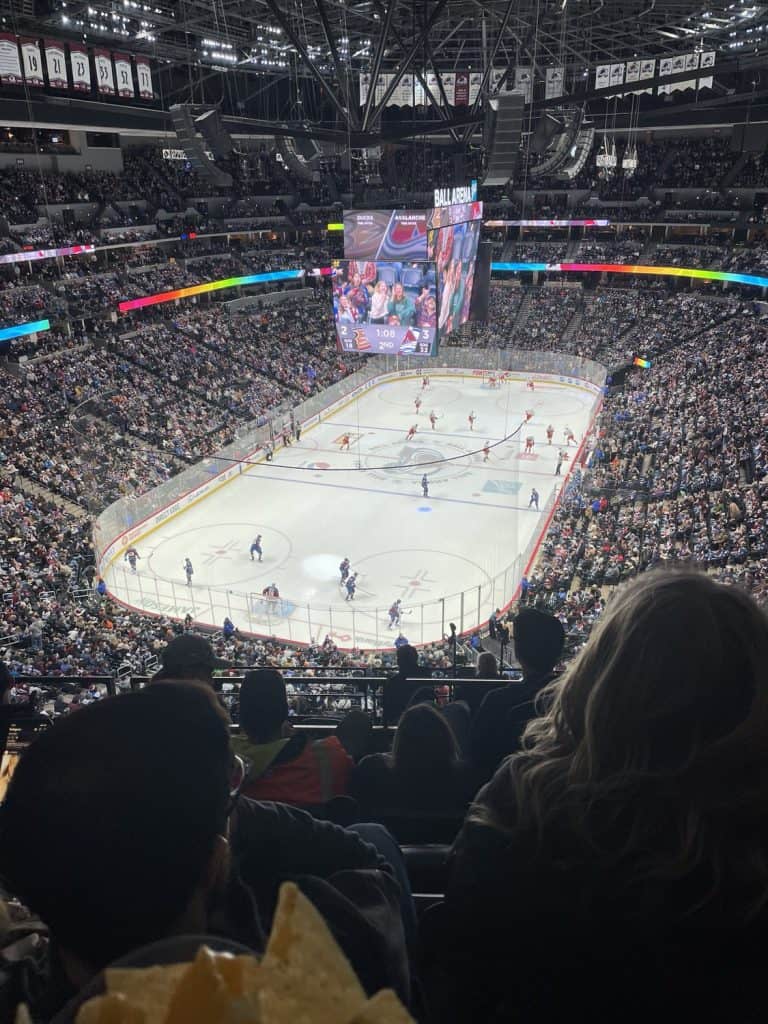 People sitting in a stadium while watching ice hockey in Colorado.